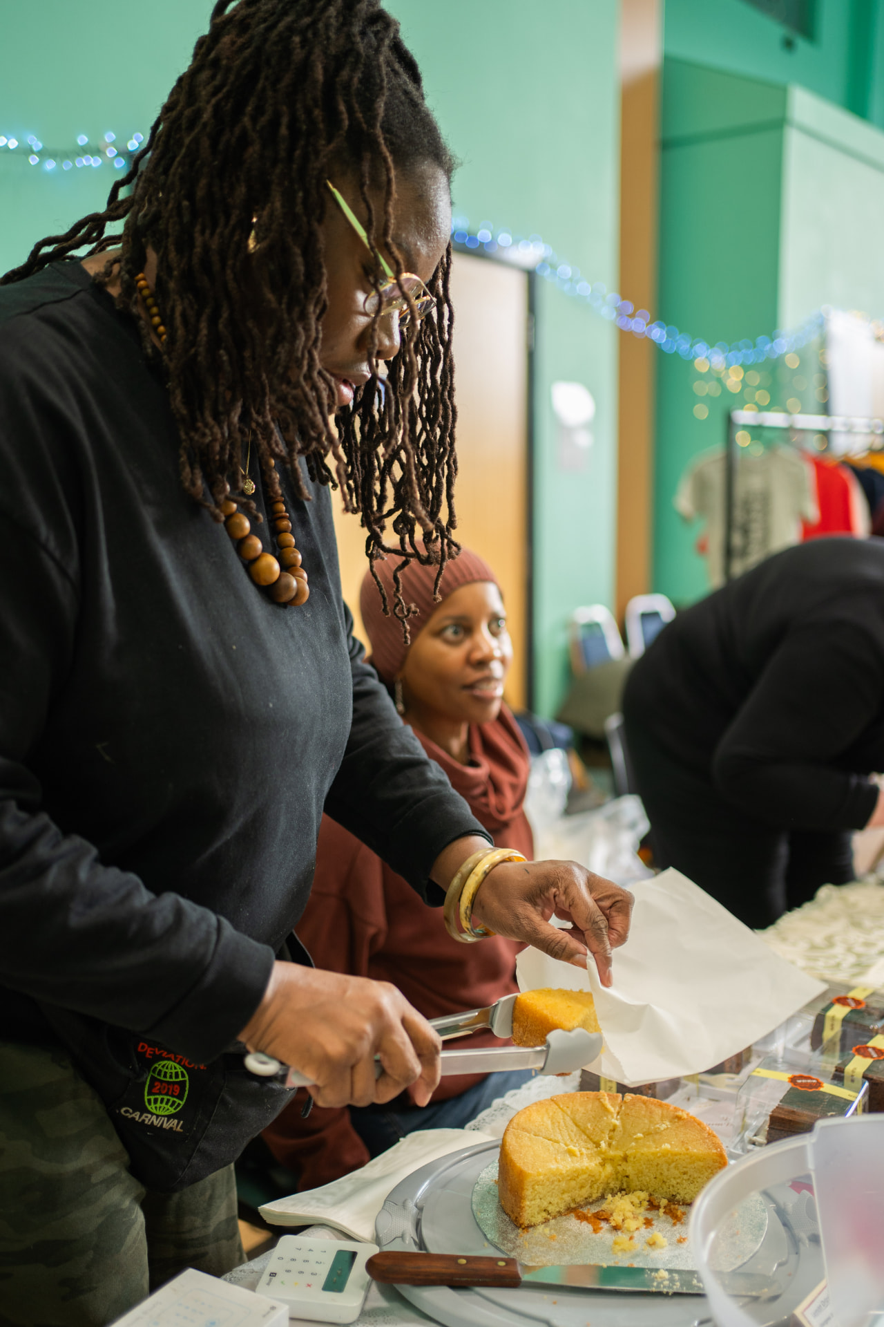 Resident serving cake at the Clapham Park winter event