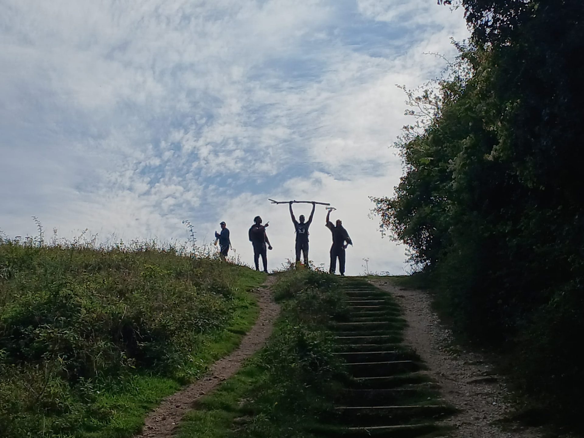Group of residents celebrating at the top of a hill on a community walk